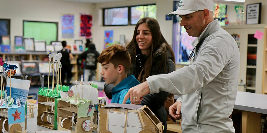 Family exploring projects at last year's AIM Showcase.