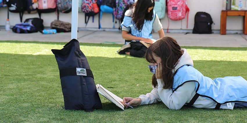 student reading outdoors