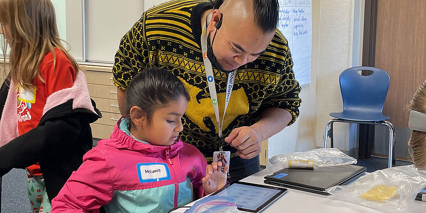 teacher works one-on-one with student