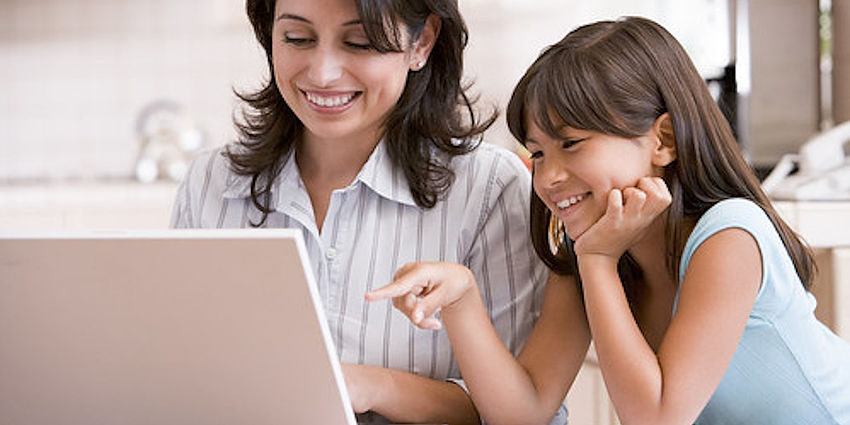 mother and daughter at laptop