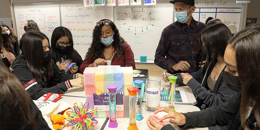 students at table working on crafts