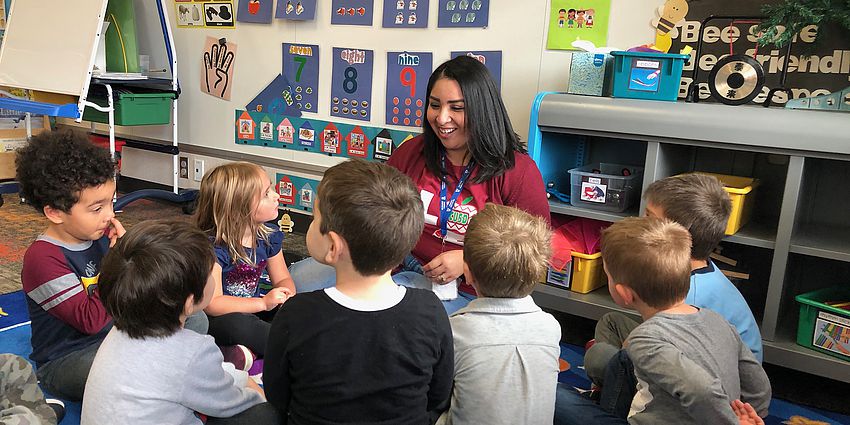 woman showing preschoolers the letter Y