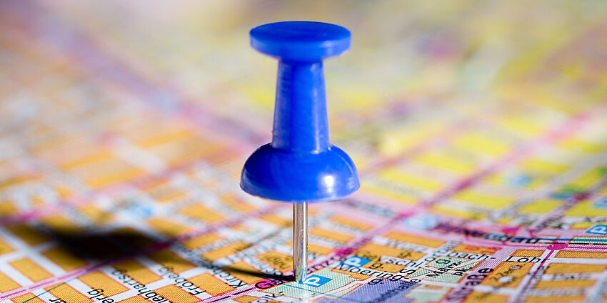 blue pushpin on a map