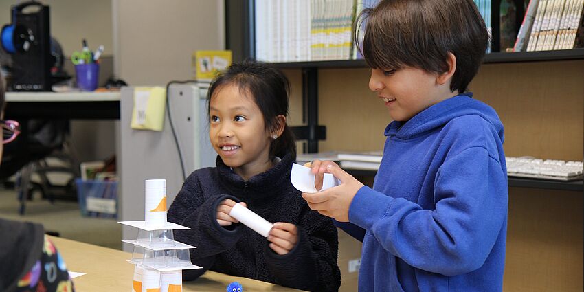 students build a tower from paper and tape