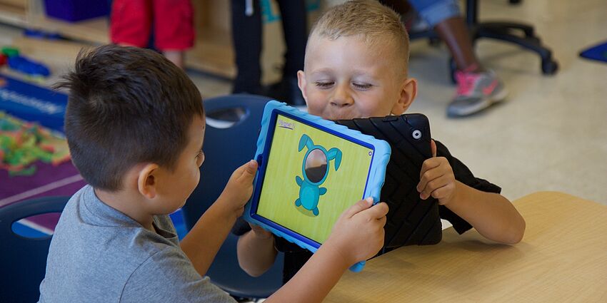 young students learning with technology
