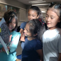 Students looking at a new book